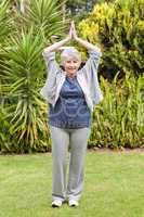 Mature woman doing her streches in the garden