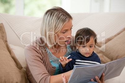 Mother looking at a book with her son
