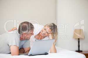 Lovely couple looking at their laptop