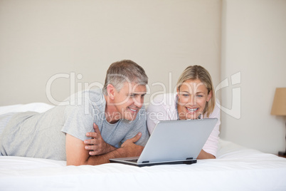 Lovely couple looking at their laptop