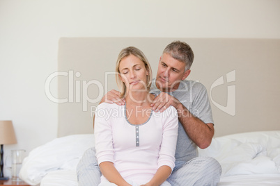 Man giving a massage to his wife