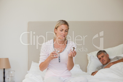 Woman taking pills at home