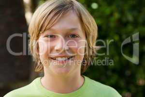 Little boy looking at the camera in the garden