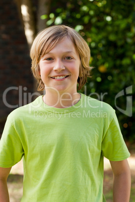 Little boy looking at the camera in the garden