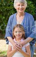 Grandmother with her granddaughter looking at the camera in the