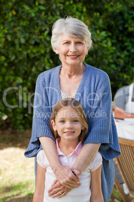 Grandmother with her granddaughter looking at the camera in the