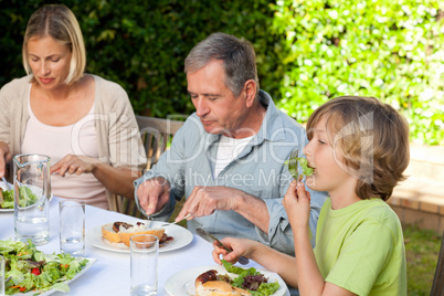 Adorable family eating in the garden