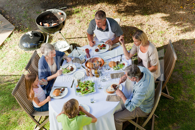 Adorable family eating in the garden