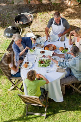 Adorable family eating in the garden