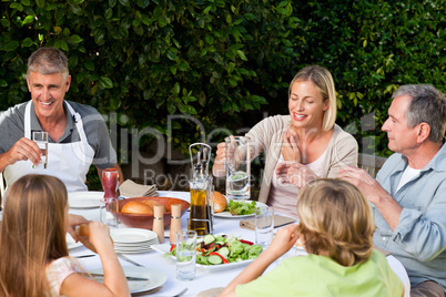 Lovely family eating in the garden