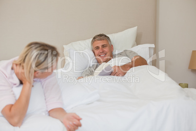 Woman talking with her husband in bed