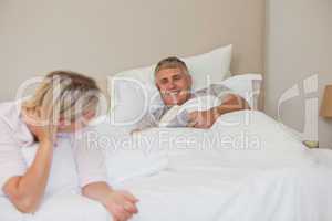 Woman talking with her husband in bed