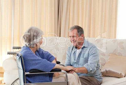 Senior couple talking in the living room at home