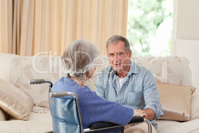 Senior couple talking in the living room at home