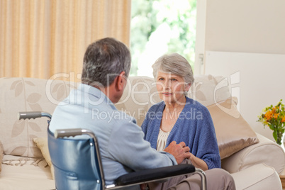 Senior couple talking in the living room at home