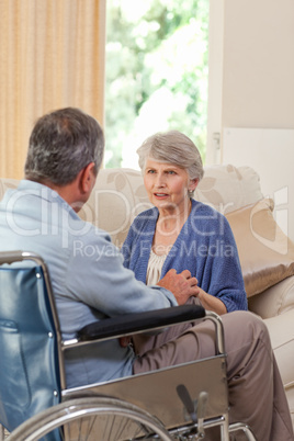 Senior couple talking in the living room at home