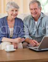 Retired couple looking at their laptop