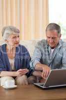 Retired couple looking at their laptop