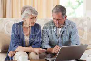 Retired couple looking at their laptop