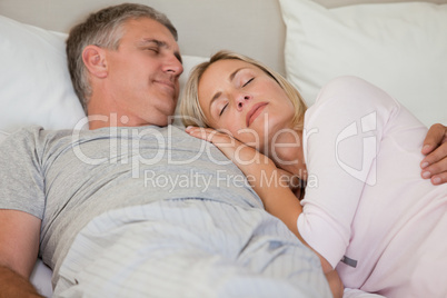 Beautiful couple sleeping on their bed
