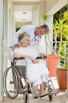 Senior doctor talking with his patient