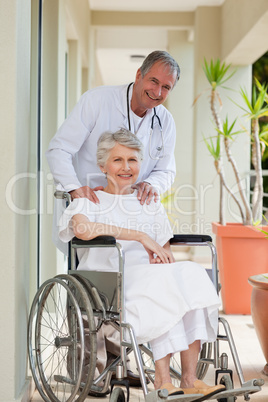 Doctor with his patient looking at the camera