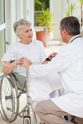 Senior doctor talking with his patient