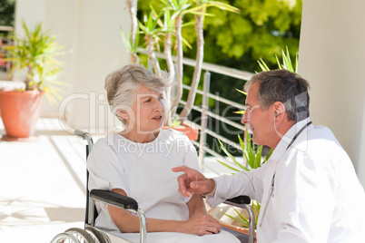 Senior doctor talking with his patient