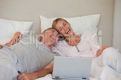 Lovely couple looking at their laptop