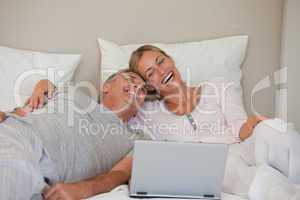 Lovely couple looking at their laptop