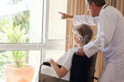 Doctor with his patient looking out the window