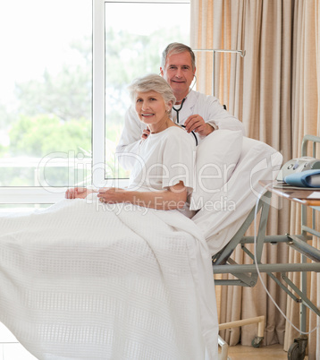 Senior doctor taking the heartbeat of his patient