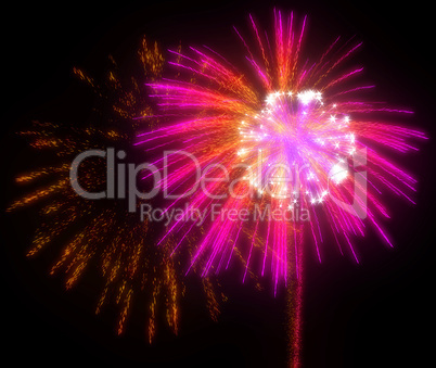 Festive red and lilac fireworks at night