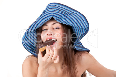 Pretty girl in hat eating chocolate cake isolated on white