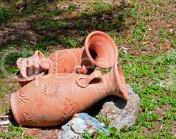 Greek amphoras lying on green grass