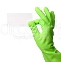 Hand in green glove showing business card