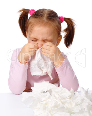 Little girl blows her nose