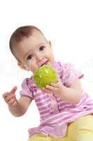 Baby girl in pink eating apple