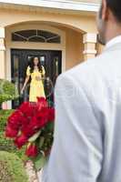 Romantic African American Man Bringing Flowers to Wife or Girlfr