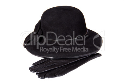 Images of a female hat lying on the leather gloves, isolated, on