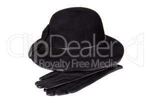 Images of a female hat lying on the leather gloves, isolated, on