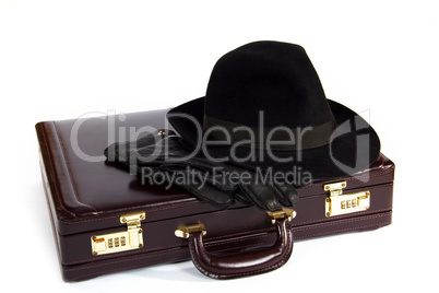 Suitcase with laying from above a hat and gloves