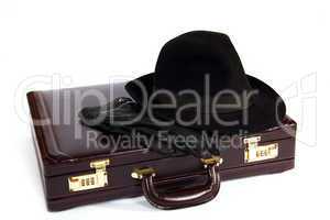 Suitcase with laying from above a hat and gloves