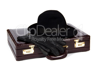 Suitcase with laying from above a hat and gloves