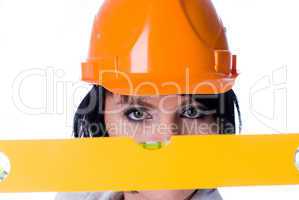 Woman in helmet with level