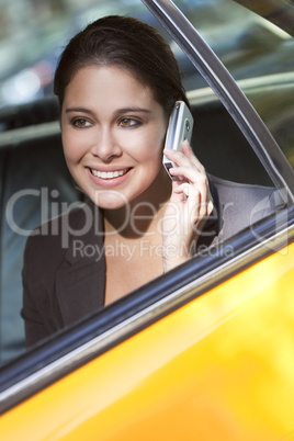 Young Woman Talking on Cell Phone in Yellow Taxi