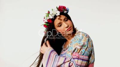 Young girl with garland take care of long hair - ethnic dress