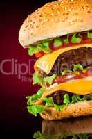 Tasty and appetizing hamburger on a darkly red