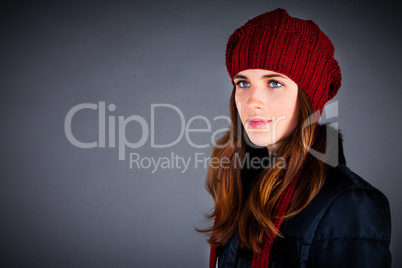 Portrait of the young girl in a winter cap on the dark