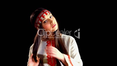Beauty girl in russian costume before mirror